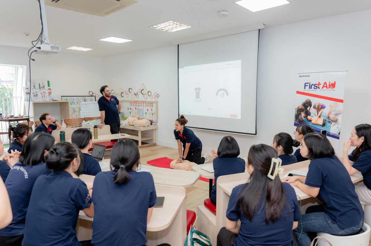 Teachers practise Cardiopulmonary Resuscitation (CPR) on child-sized medical manikins under the direct guidance of certified professionals